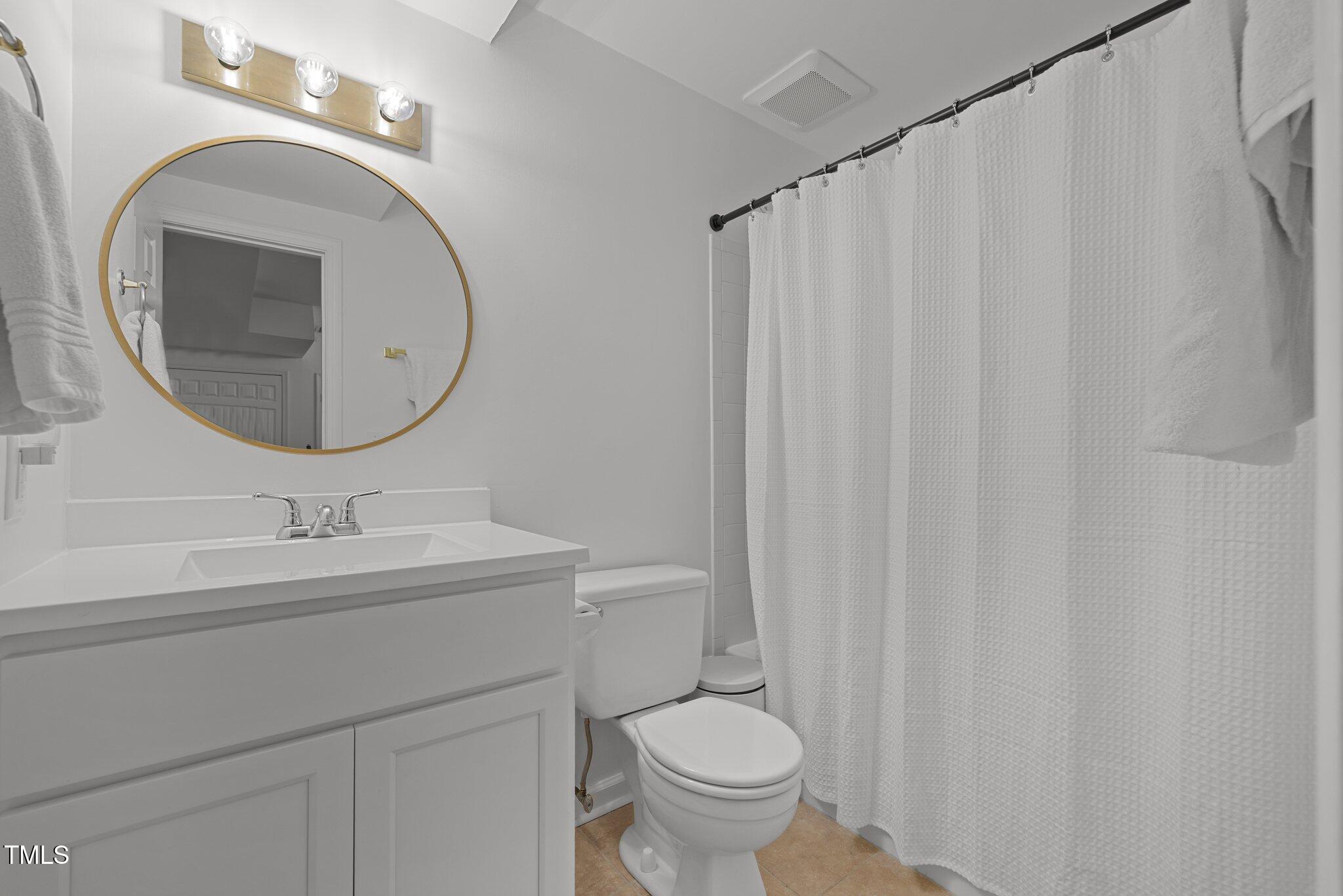 1706 Rangecrest Road Raleigh, NC 27612 - Photo 26 of 43 a bathroom with a toilet sink and mirror