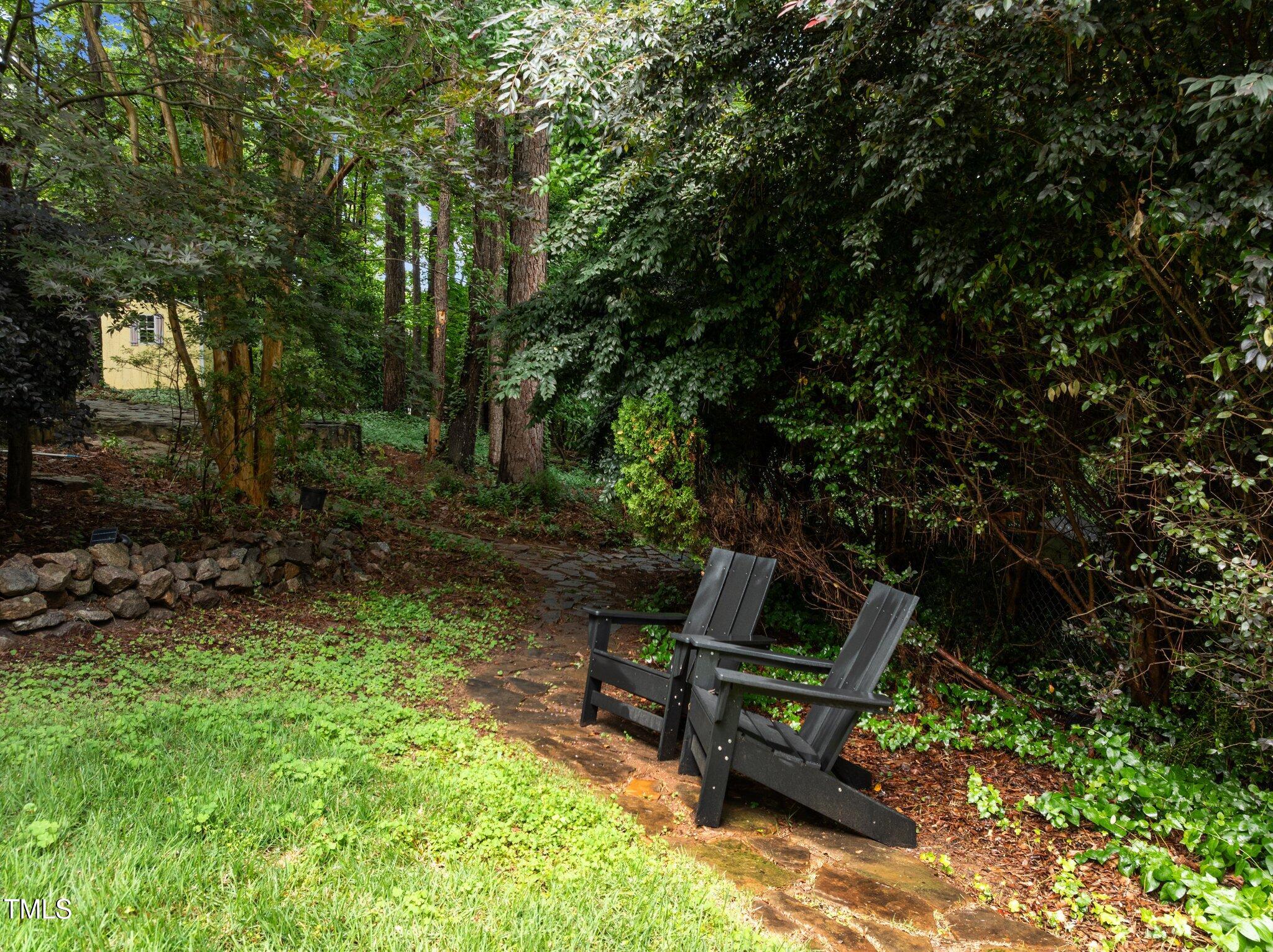 1706 Rangecrest Road Raleigh, NC 27612 - Photo 42 of 43 a wooden bench sitting in the middle of a forest