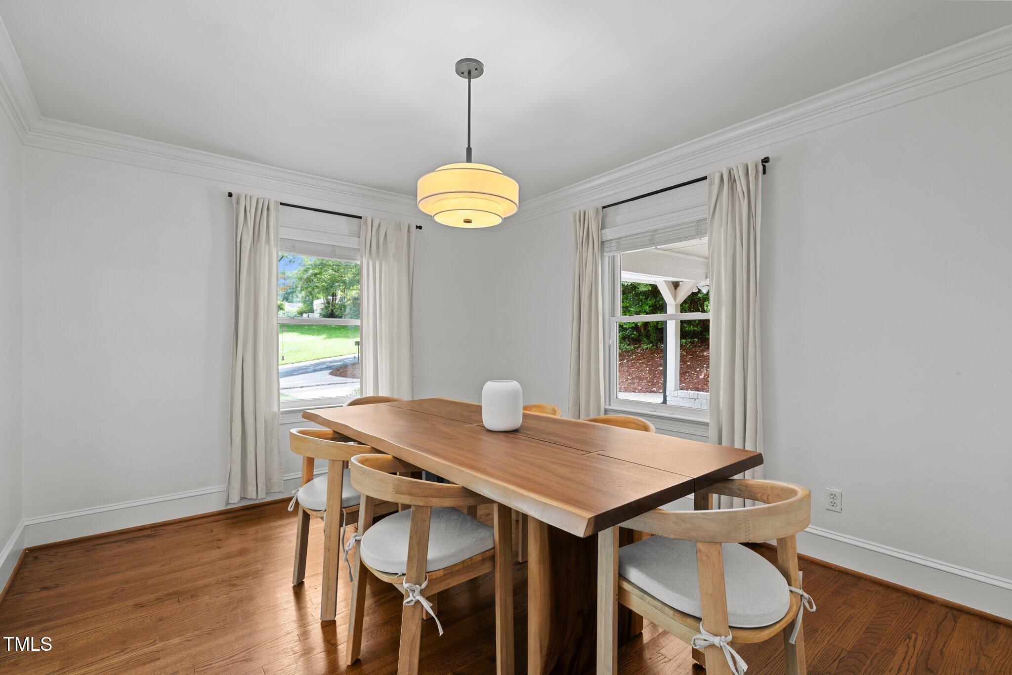 1706 Rangecrest Road Raleigh, NC 27612 - Photo 9 of 43 a view of a dining room with a table and chairs