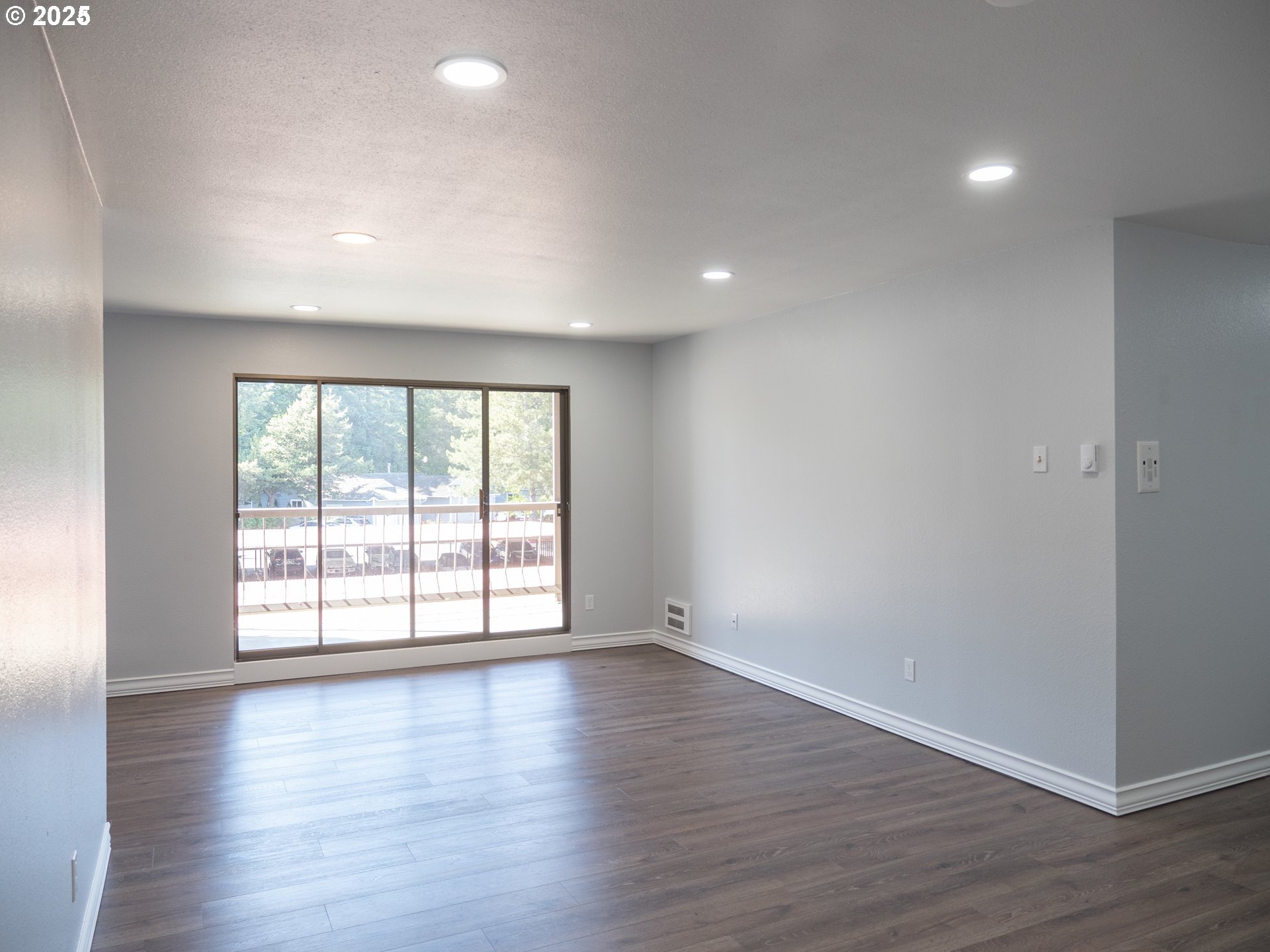 45 Eagle Crest Drive, Unit 407 Lake Oswego, OR 97035 - Photo 11 of 28 a view of an empty room with wooden floor and a window