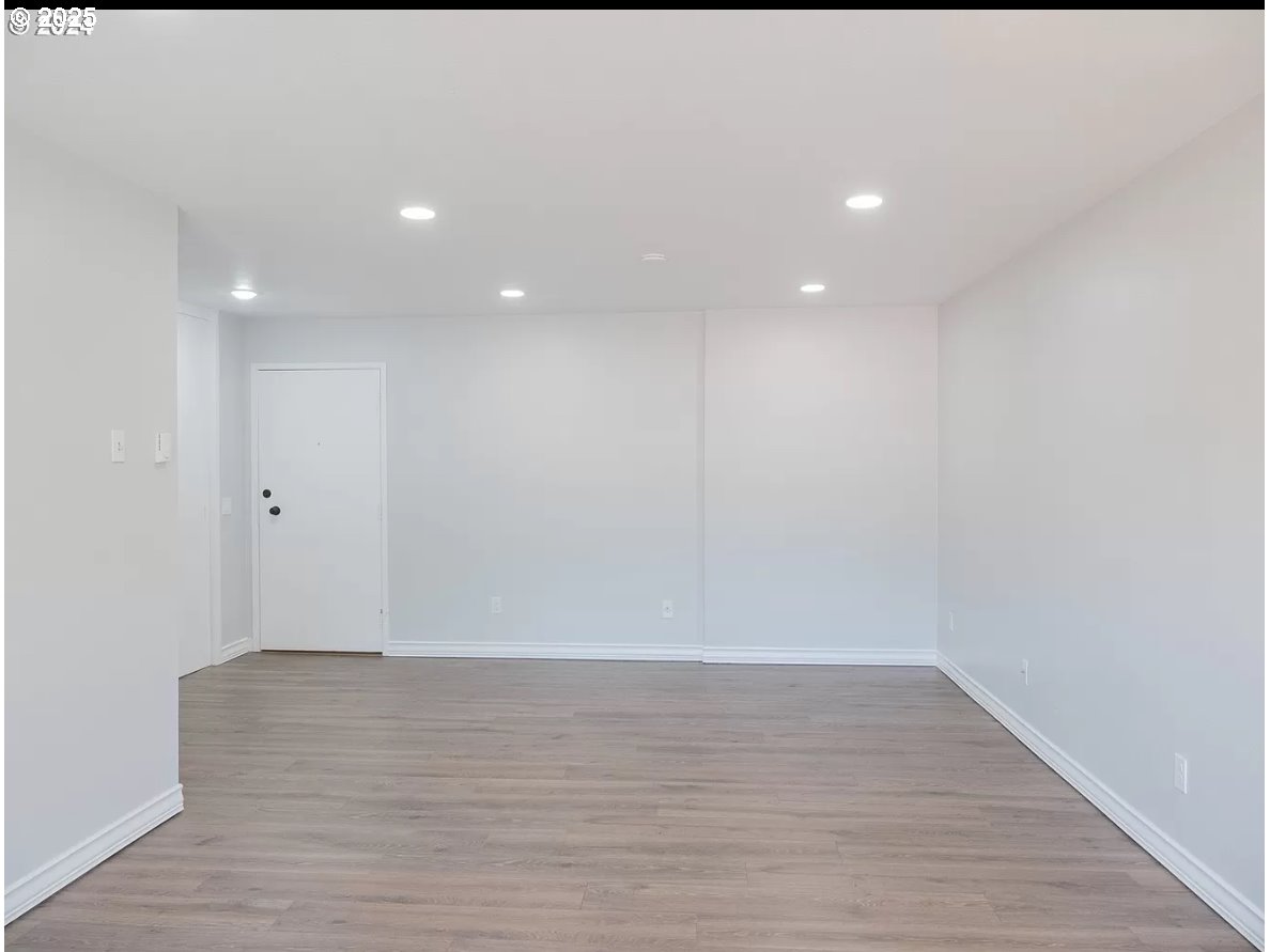 45 Eagle Crest Drive, Unit 407 Lake Oswego, OR 97035 - Photo 2 of 28 a view of an empty room with wooden floor