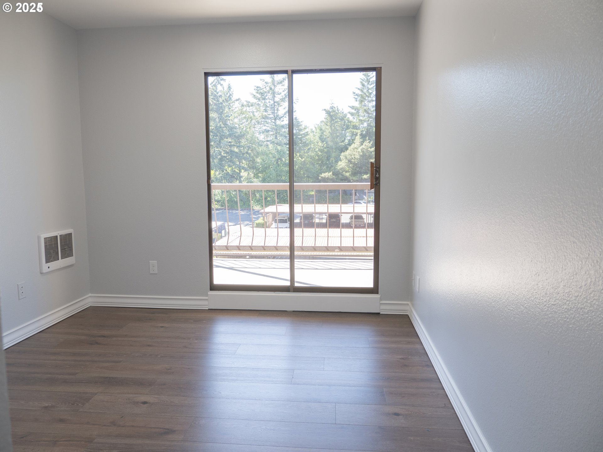 45 Eagle Crest Drive, Unit 407 Lake Oswego, OR 97035 - Photo 21 of 28 a view of an empty room with wooden floor and a window