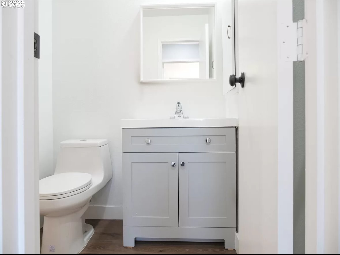 45 Eagle Crest Drive, Unit 407 Lake Oswego, OR 97035 - Photo 7 of 28 a bathroom with a sink a toilet and a mirror