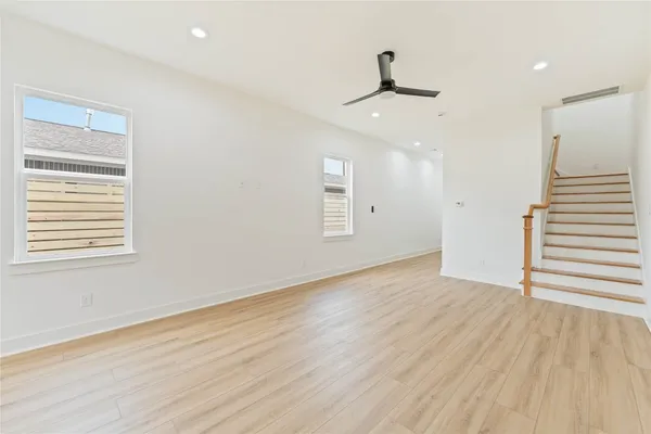 wooden floor in an empty room with a window
