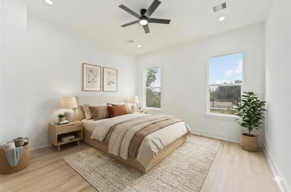 a bedroom with a large bed and a window