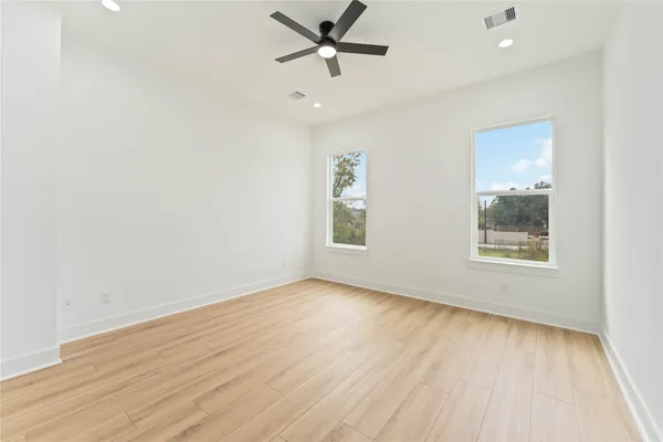 wooden floor in an empty room with a window