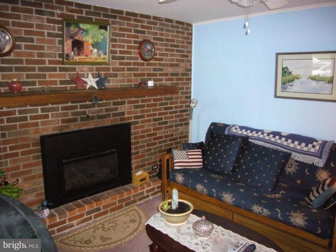 10160 High Ridge Road Laurel, MD 20723 - Photo 8 of 16 LIVING ROOM SHOWING WOOD BURNING FIREPLACE