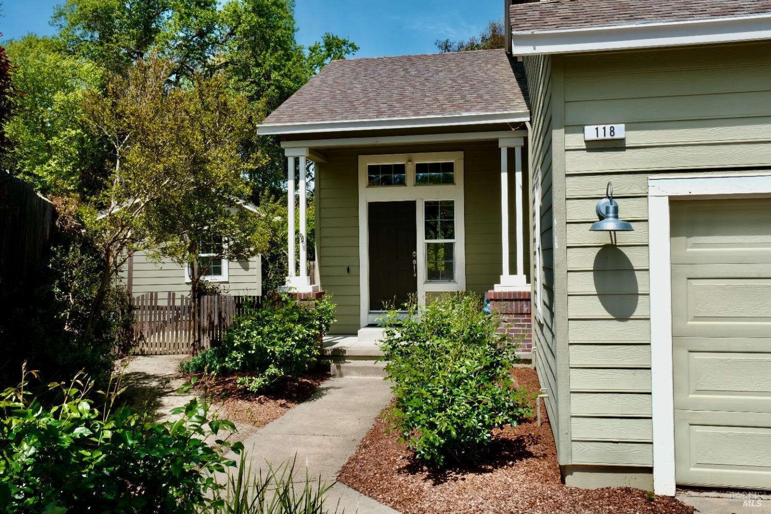 a view of a house with potted plants