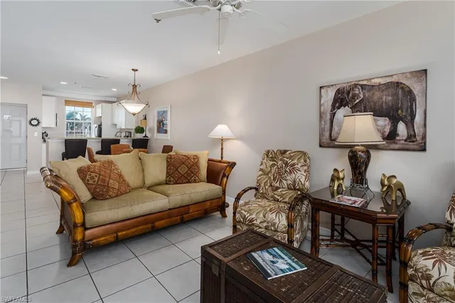 a living room with furniture and a painting on the wall