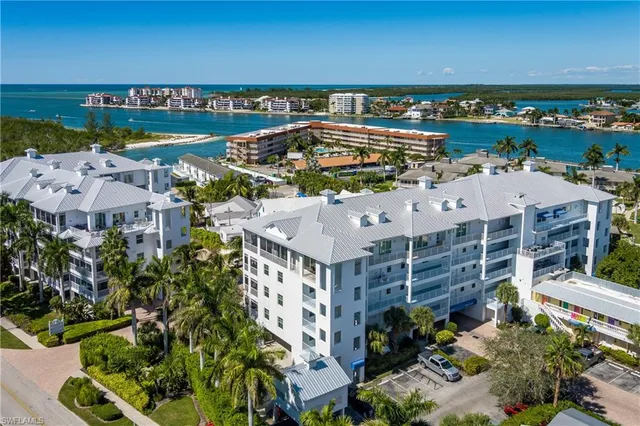 an aerial view of a building with garden space and ocean view