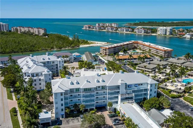 an aerial view of a house with a garden and lake view