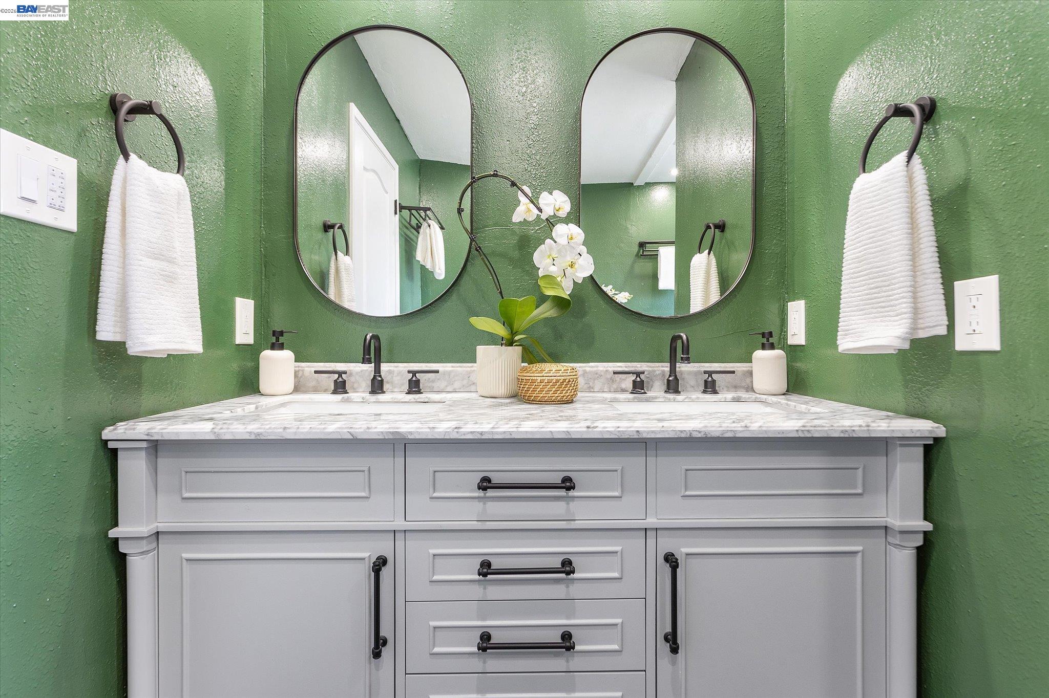 16683 Kildare Road Castro Valley, CA 94546 - Photo 53 of 77 a bathroom with double vanity sinks and a mirror