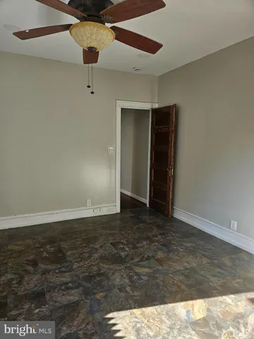 a view of an empty room with a ceiling fan