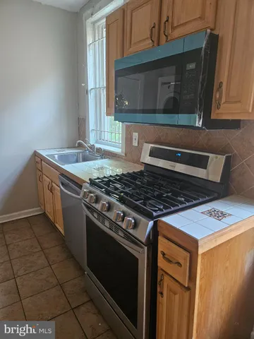 a stove top oven sitting inside of a kitchen