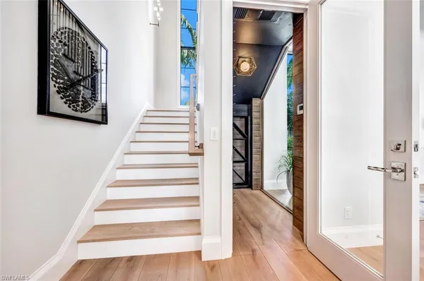 a view of entryway and hall with wooden floor