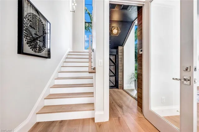 a view of entryway and hall with wooden floor