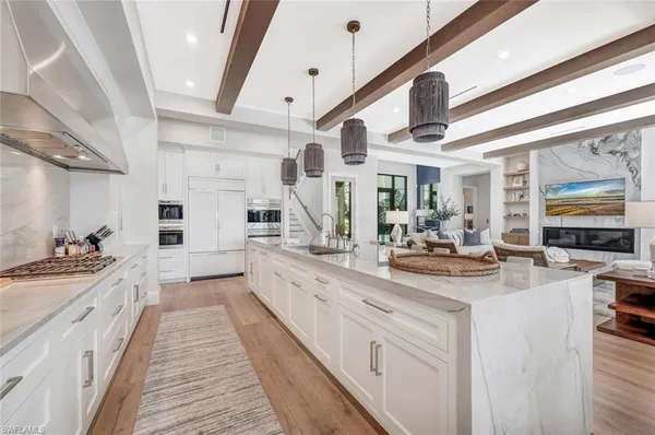 a large white kitchen with a large window
