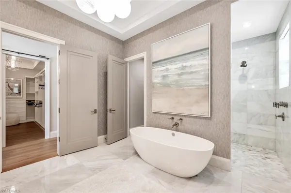 a spacious bathroom with a bathtub and a shower