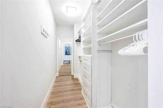 a view of a hallway with wooden floor and entryway