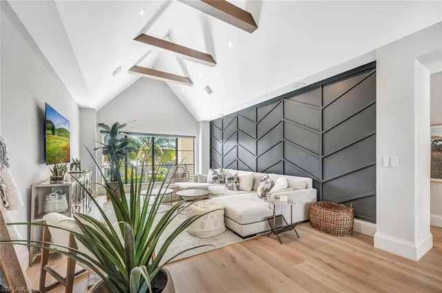 a bedroom with furniture and a large window