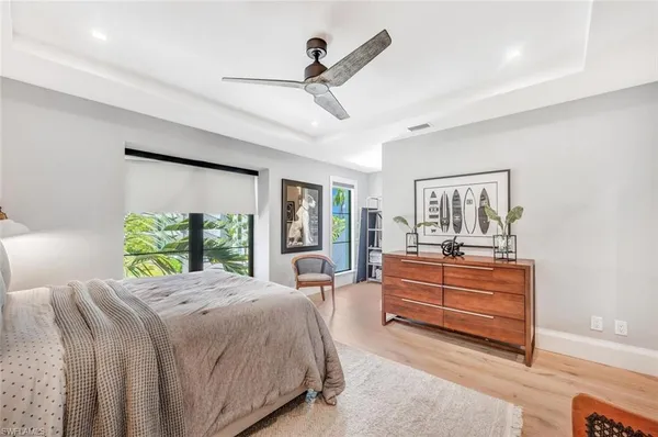 a bed room with a bed and a large window