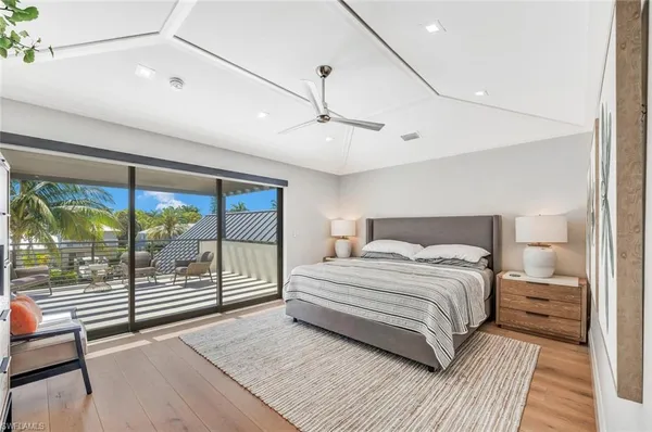 a bedroom with a large bed and a large window