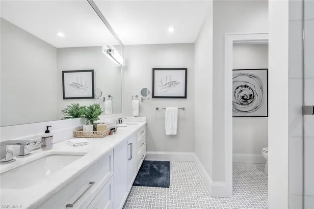 a spacious bathroom with a double vanity sink and a mirror