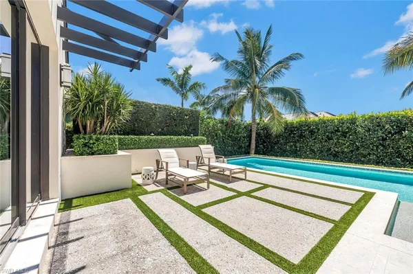 a view of swimming pool with a patio and a garden