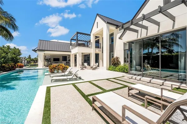 a view of a building with a yard and sitting area