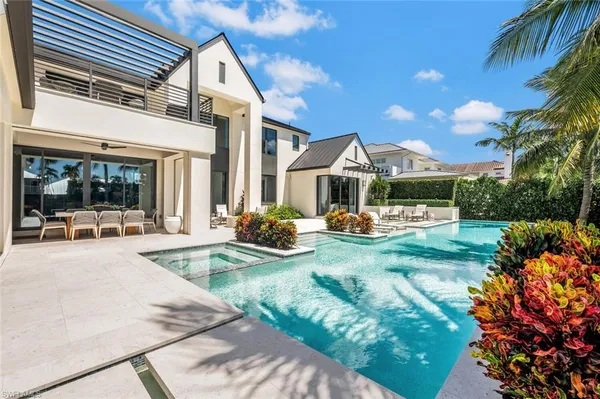 a view of a house with backyard and sitting area