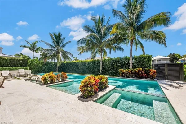 a view of backyard with outdoor seating a patio and palm tree