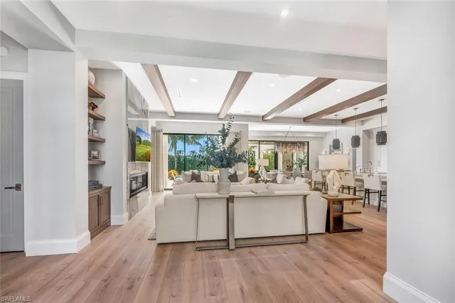 a living room with fireplace furniture and a large window