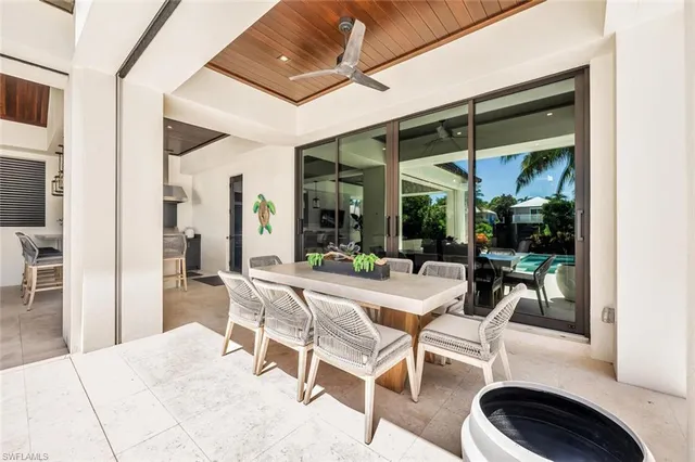 a dining room with furniture and a large window