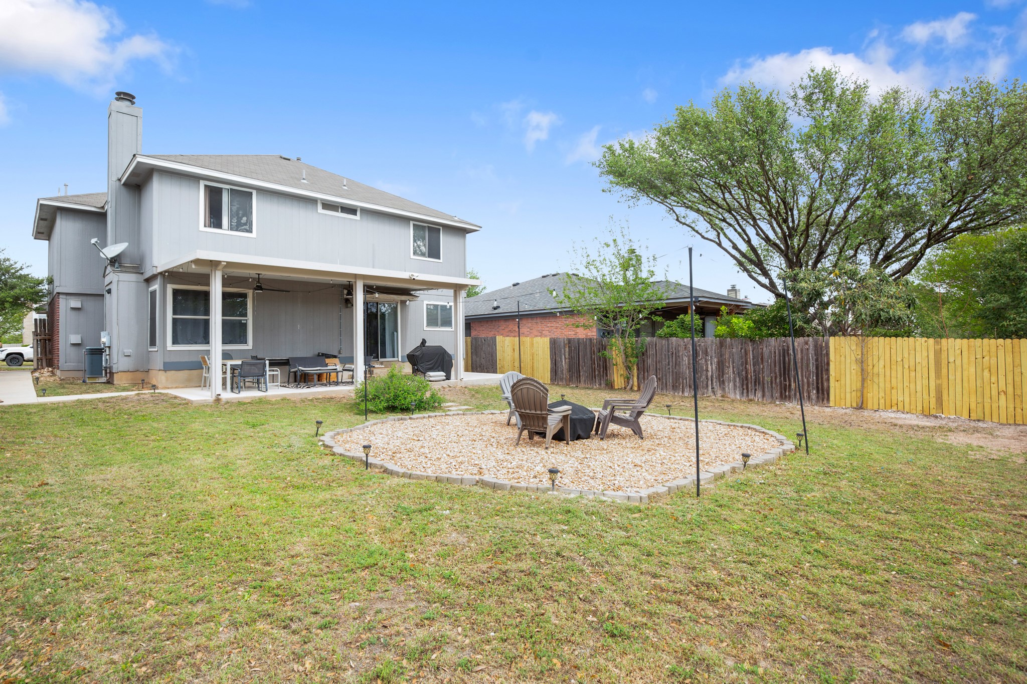 13803 Randalstone Drive Pflugerville, TX 78660 - Photo 5 of 27 Rear view of house featuring a patio, an outdoor fire pit, a ceiling fan, a chimney, and a fenced backyard