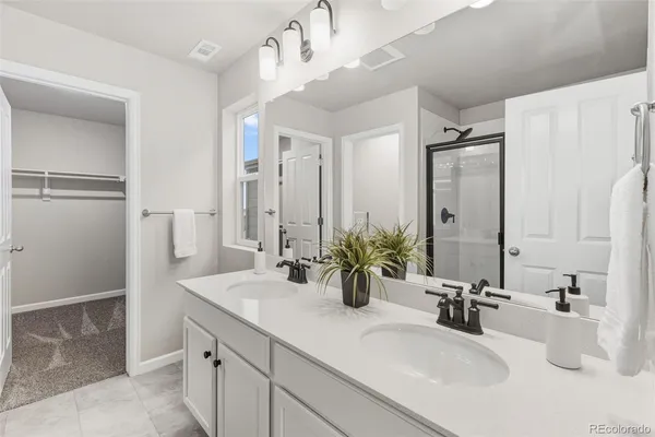 a bathroom with a double vanity sink mirror and double