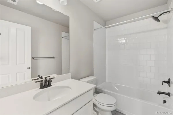 a bathroom with a sink toilet tub and shower