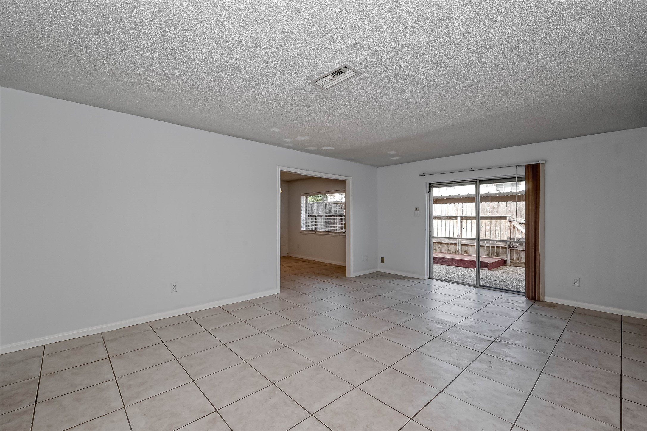 14179 Misty Meadow Lane Houston, TX 77079 - Photo 13 of 41 a view of an empty room with window and chandelier