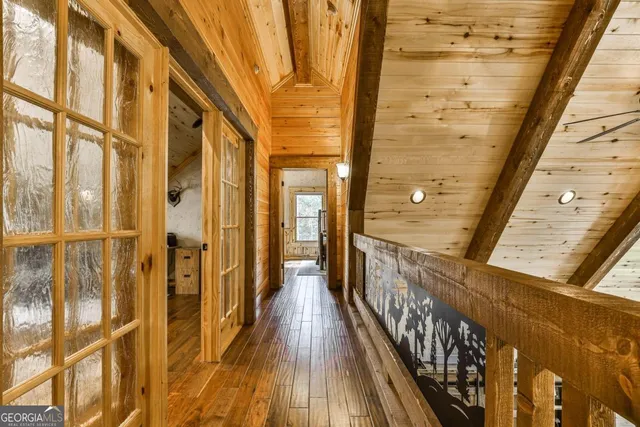 a bedroom with a bed a dresser next to a window