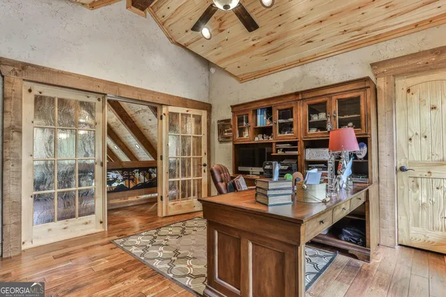 a bedroom with furniture and a large window