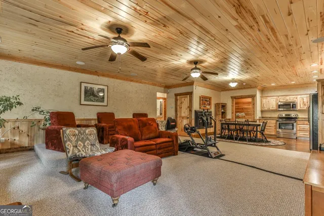 a front view of a house with a yard and large trees