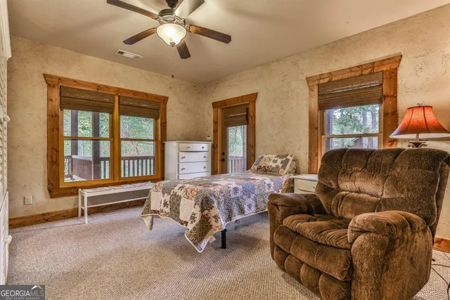 a living room with furniture a fireplace and wooden floor