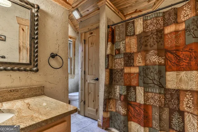 a bedroom with a bed next to a window with the outer view