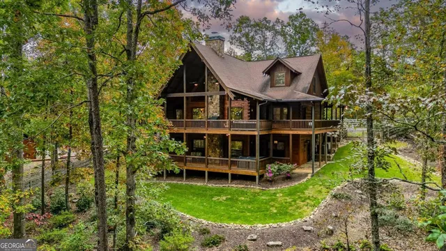 a living room with furniture a fireplace and wooden floor
