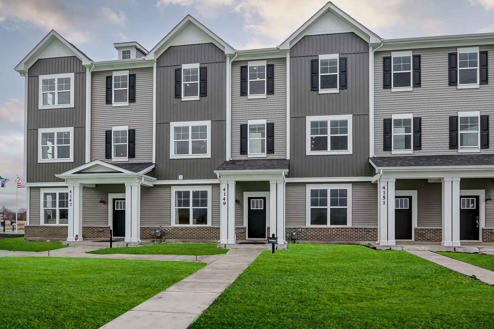 4465 Chelsea Mnr Circle Aurora, IL 60504 - Photo 1 of 30 front view of a brick building with a yard
