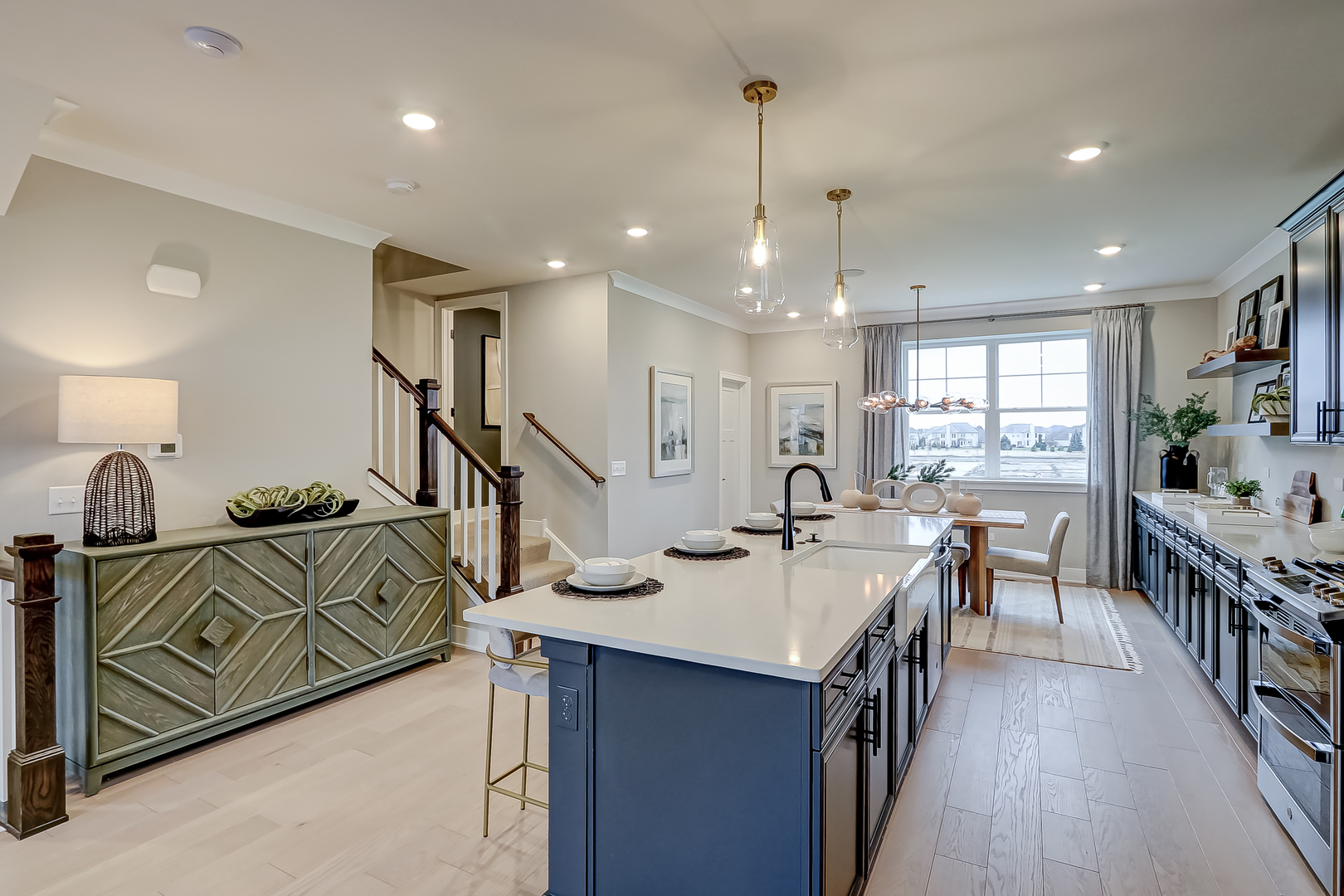 4465 Chelsea Mnr Circle Aurora, IL 60504 - Photo 16 of 30 a view of a dining room and livingroom with furniture wooden floor a chandelier