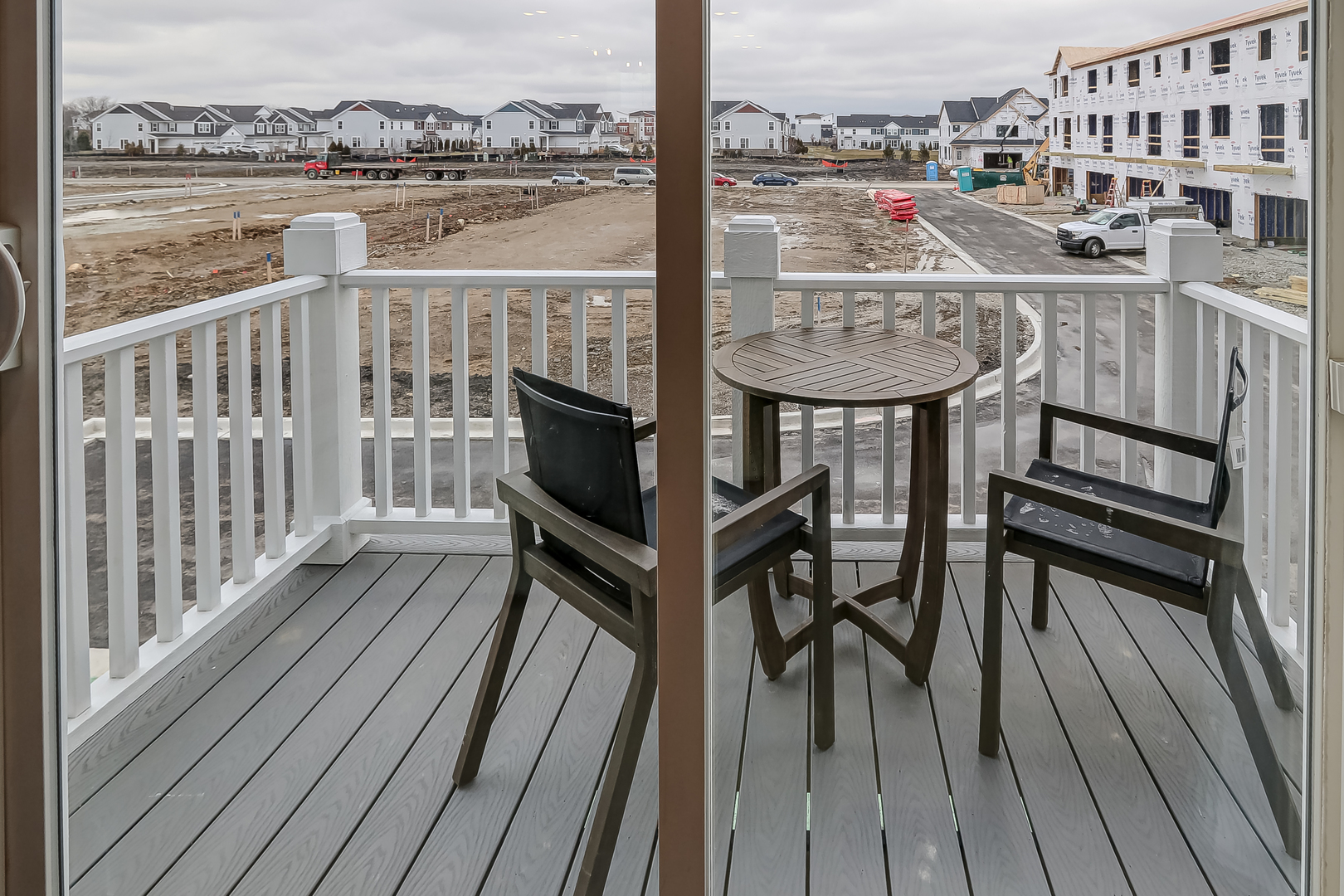 4465 Chelsea Mnr Circle Aurora, IL 60504 - Photo 19 of 30 a view of a balcony with chair and wooden floor