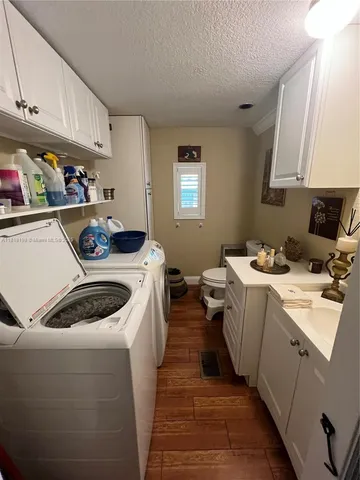 a utility room with sink dryer and washer