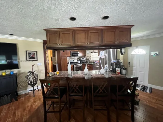 a view of a dining room with furniture and wooden floor