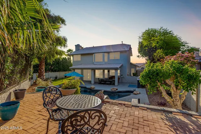 a view of a patio with couches table and chairs and potted plants