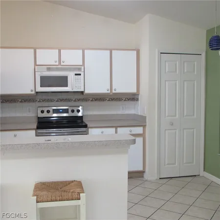 a kitchen with stainless steel appliances a stove microwave and refrigerator